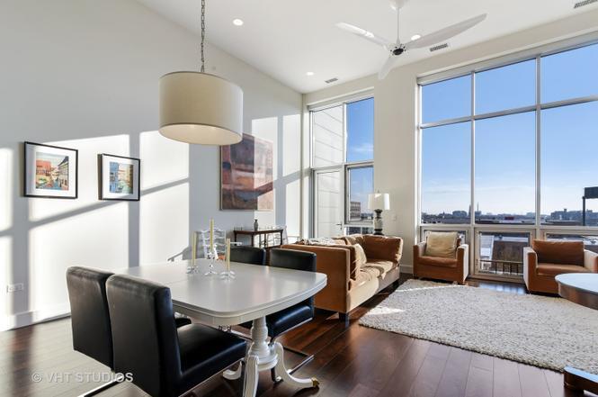 1132 West Adams Street, Unit PHE Chicago, IL 60607 - Photo 2 of 23 a dining room with furniture a window and a chandelier