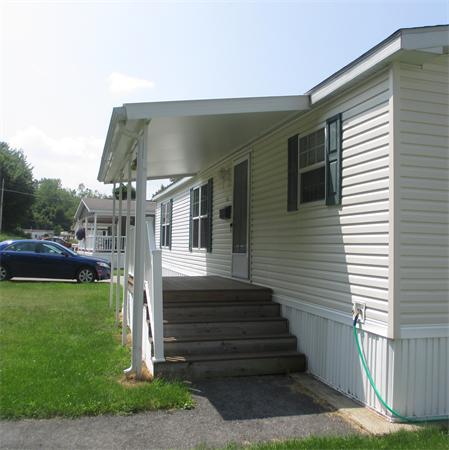 32 Lower Windbrook Drive, Unit 32 Auburn, MA 01501 - Photo 2 of 13 a front view of a house with a yard