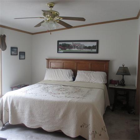 32 Lower Windbrook Drive, Unit 32 Auburn, MA 01501 - Photo 8 of 13 a bedroom with a bed and a chandelier fan