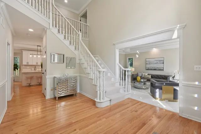 a view of entryway and kitchen with wooden floor