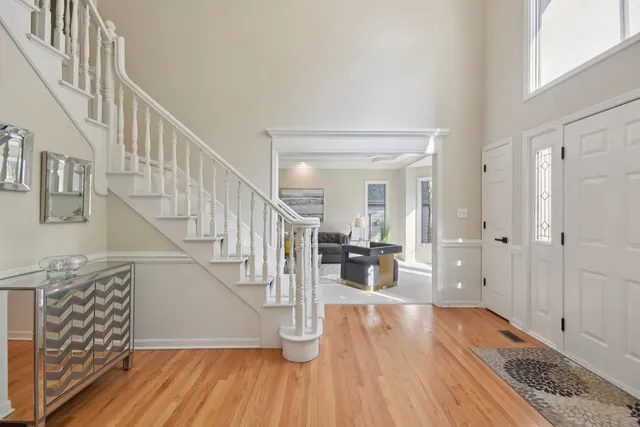a view of entryway and hall with wooden floor