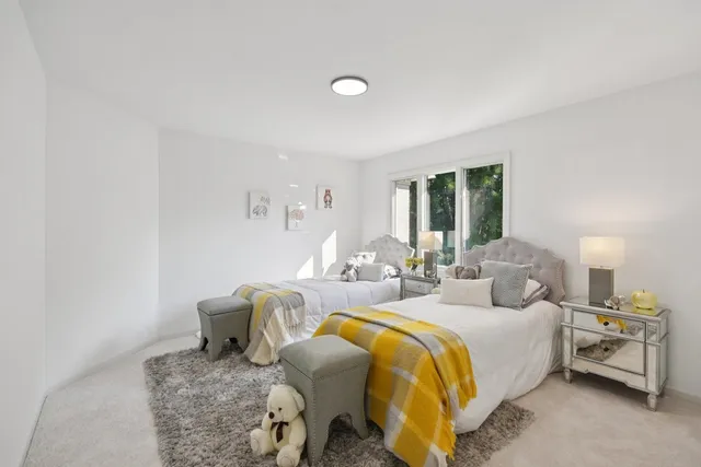 a bedroom with bed and glass windows