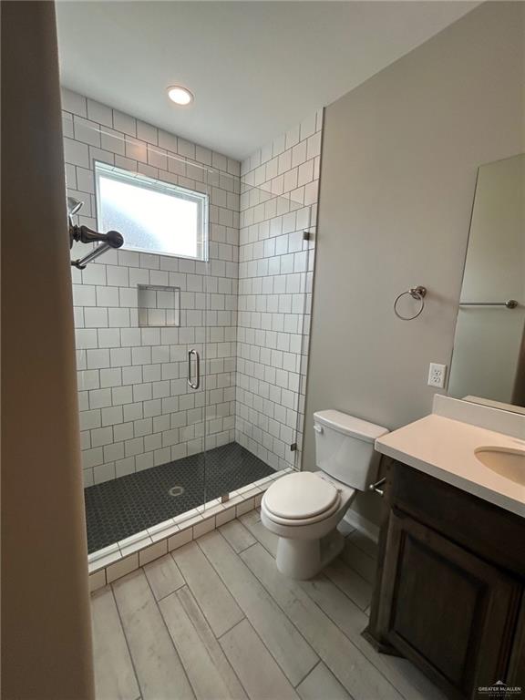 3524 Emory Avenue McAllen, TX 78504 - Photo 11 of 11 a bathroom with a sink a toilet a mirror and shower
