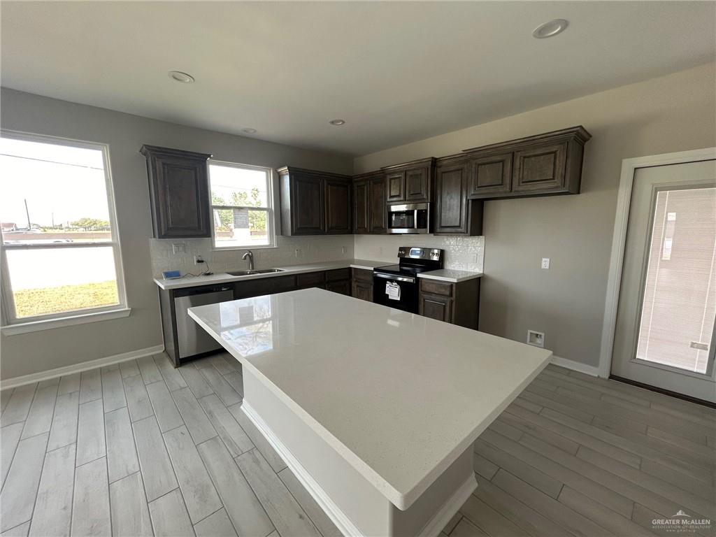 3524 Emory Avenue McAllen, TX 78504 - Photo 4 of 11 a kitchen with stainless steel appliances a refrigerator sink and cabinets