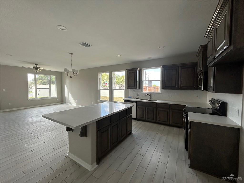 3524 Emory Avenue McAllen, TX 78504 - Photo 8 of 11 a kitchen with granite countertop a sink counter top space and cabinets