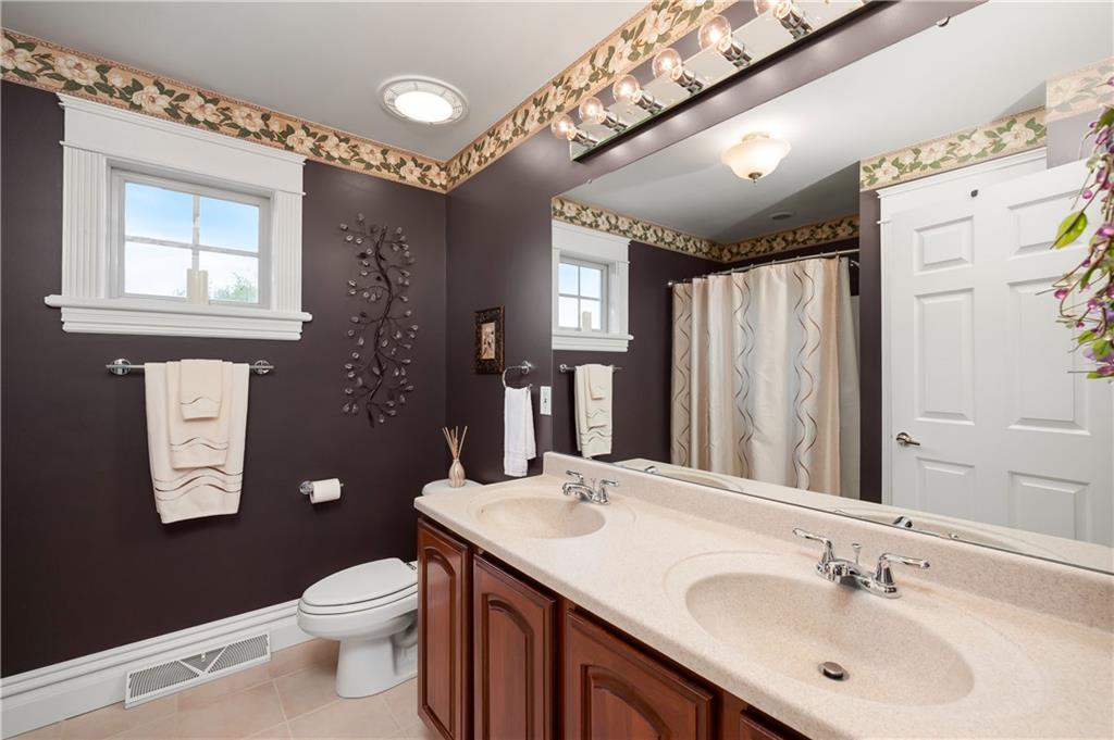 829 Hartzell School Road New Brighton, PA 15066 - Photo 23 of 50 a bathroom with a sink vanity granite toilet and a mirror
