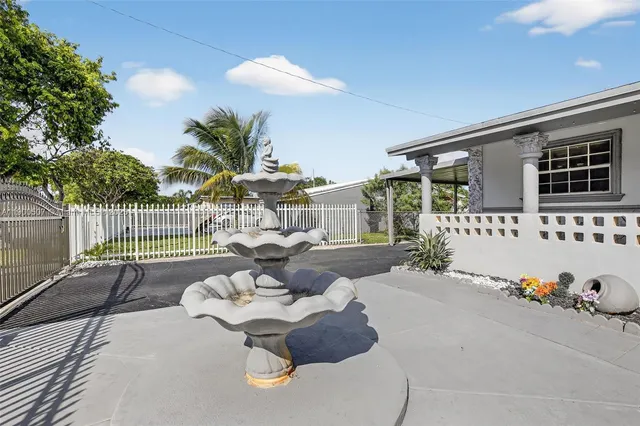a view of a patio with couches table and chairs and potted plants