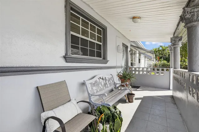 a view of a patio with table and chairs and potted plants