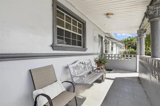 a view of a patio with table and chairs and potted plants