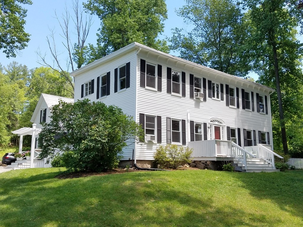 73 Frankland Road Ashland, MA 01721 - Photo 1 of 30 a front view of a house with a garden