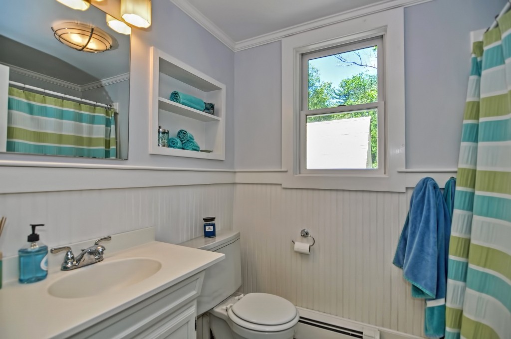73 Frankland Road Ashland, MA 01721 - Photo 29 of 30 a bathroom with a sink a toilet and a mirror