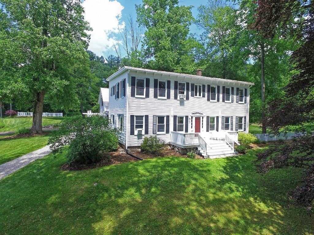 73 Frankland Road Ashland, MA 01721 - Photo 3 of 30 a front view of a house with a yard table and chairs