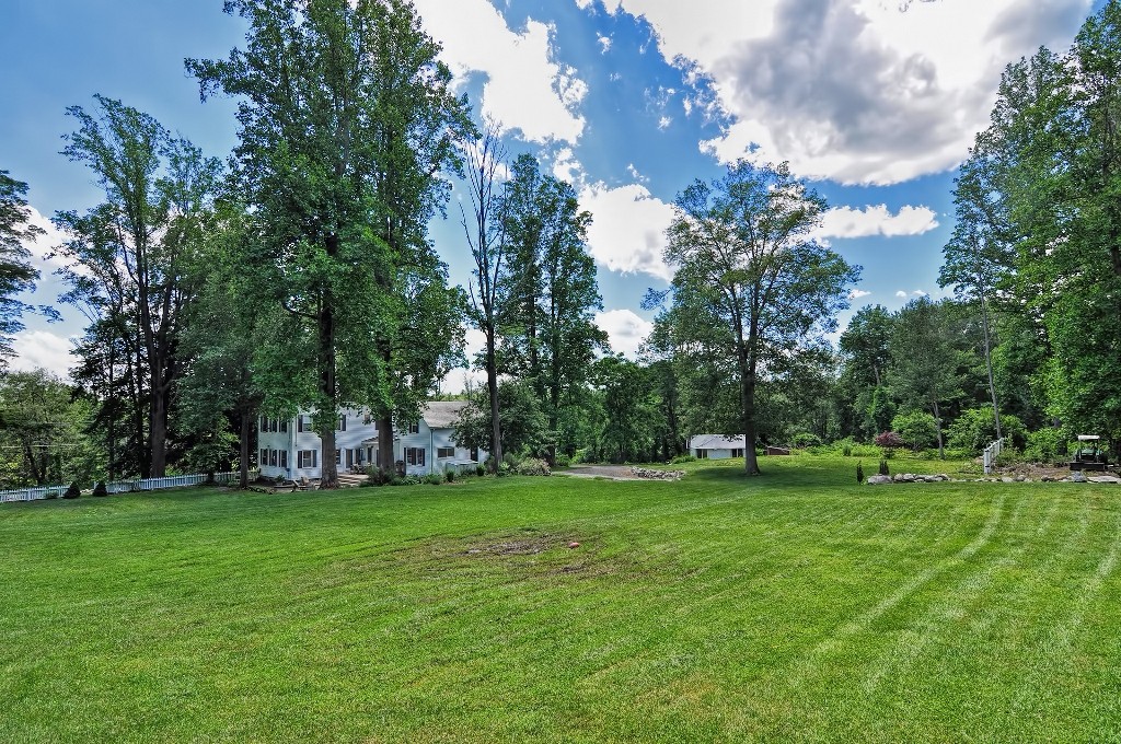 73 Frankland Road Ashland, MA 01721 - Photo 4 of 30 a view of a grassy field with trees