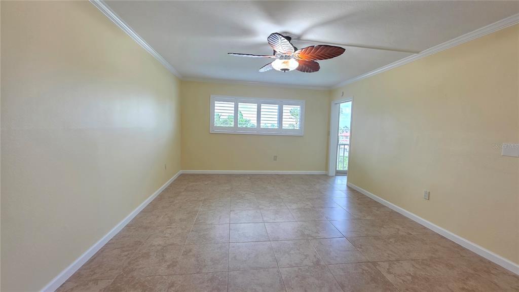 9604 Cortez Road West, Unit 213 Bradenton, FL 34210 - Photo 17 of 36 an empty room with windows and fan