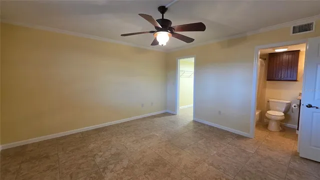 wooden floor in an empty room and a bathroom