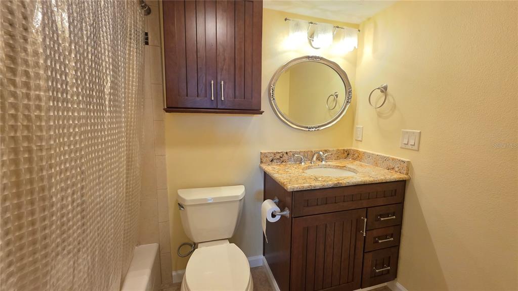 9604 Cortez Road West, Unit 213 Bradenton, FL 34210 - Photo 26 of 36 a bathroom with a granite countertop toilet sink and mirror