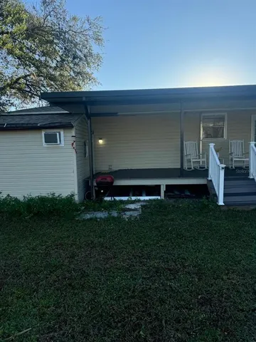 a backyard of a house with table and chairs
