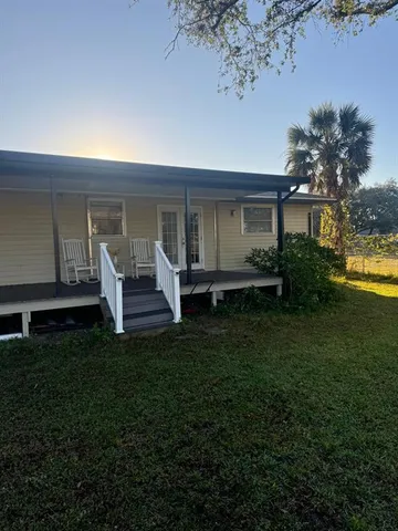 a front view of house with yard and outdoor seating