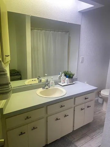 a bathroom with a double vanity sink and a mirror