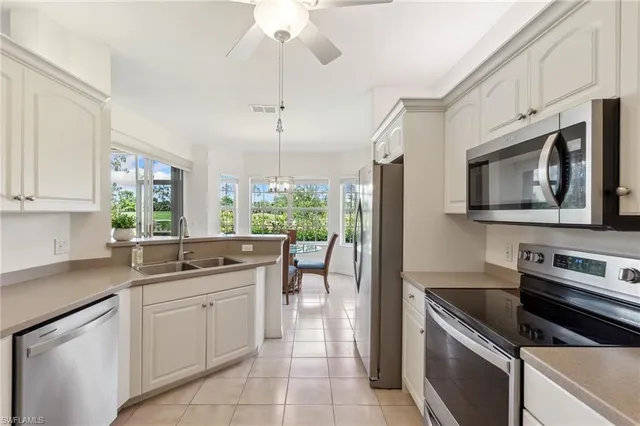 a kitchen with a sink stainless steel appliances and cabinets
