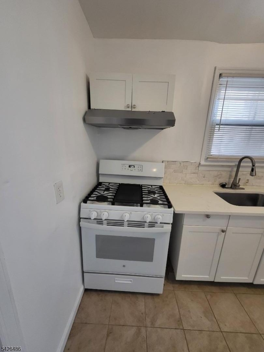 111 Pine Street Elizabeth Port, NJ 07206 - Photo 3 of 9 a white stove top oven sitting inside of a kitchen