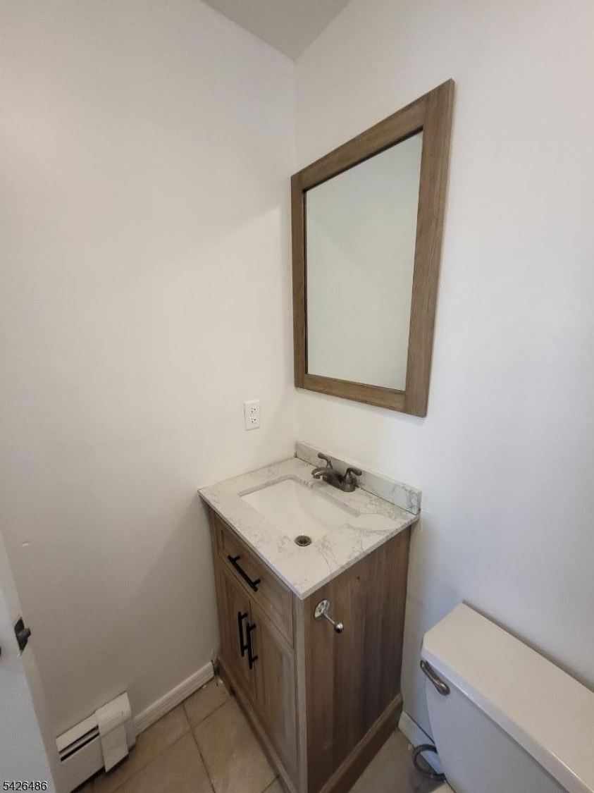 111 Pine Street Elizabeth Port, NJ 07206 - Photo 7 of 9 a bathroom with a toilet sink and mirror