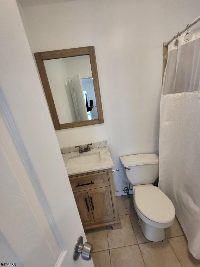 111 Pine Street Elizabeth Port, NJ 07206 - Photo 8 of 9 a bathroom with a toilet a sink and mirror