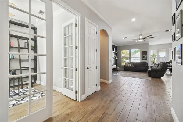 a kitchen with kitchen island granite countertop a stove a sink a center island and wooden floor