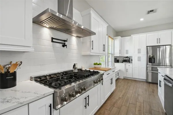 a bathroom with a granite countertop sink a mirror and a shower