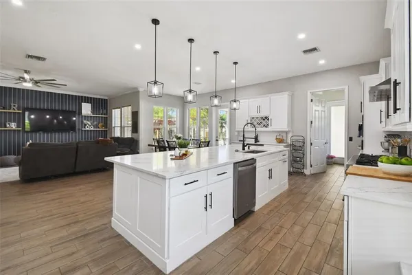 a en suite bathroom with a granite countertop sink and a mirror