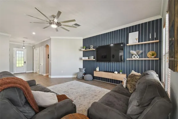 a view of a livingroom with workspace and a window