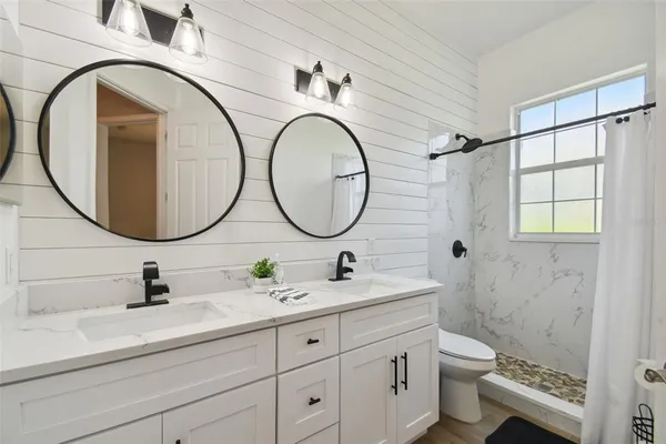 a view of a porch with a table and chairs and potted plants