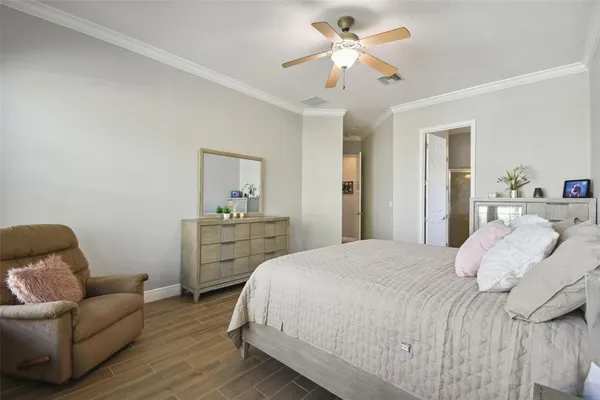 an aerial view of residential houses with outdoor space and trees