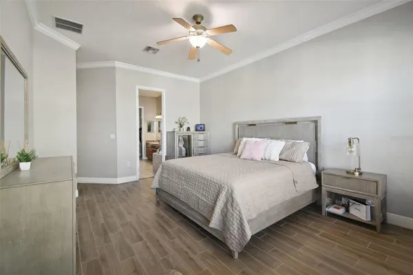 an aerial view of a house with a yard and large tree