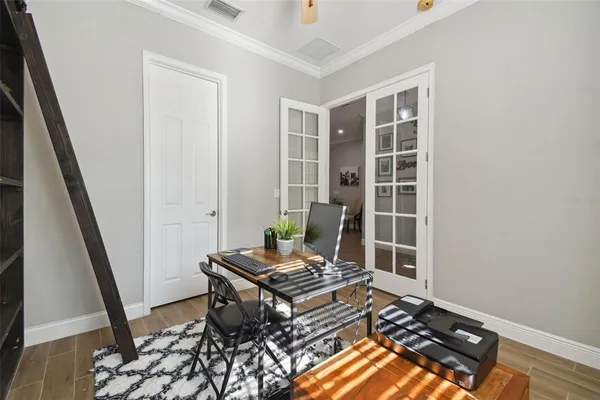 a large white dining hall with stainless steel appliances granite countertop a large window and white cabinets