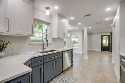 a kitchen with a sink cabinets and window