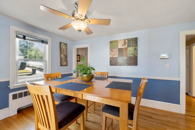 a view of a dining room with furniture window and wooden floor