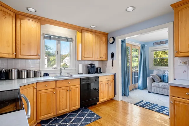 a large kitchen with kitchen island granite countertop a large window cabinets and stainless steel appliances
