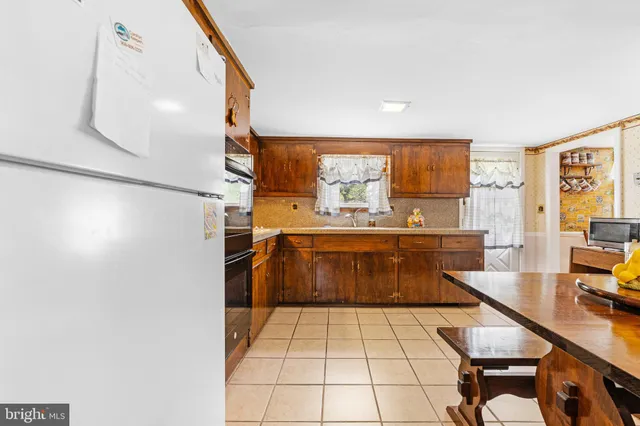 a kitchen with stainless steel appliances kitchen island granite countertop a sink and cabinets