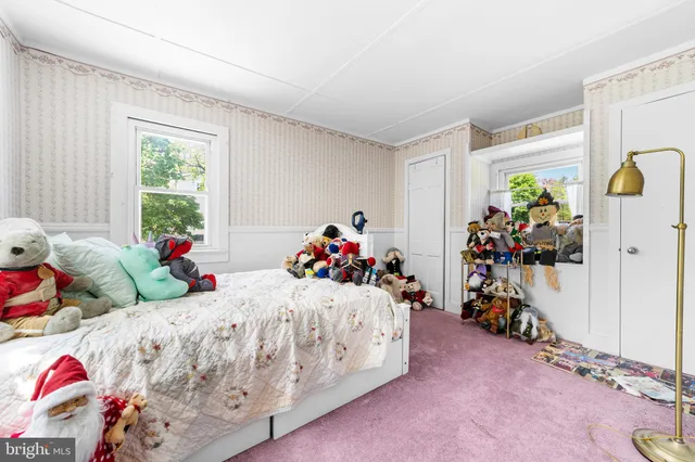 a bedroom with two beds and a window