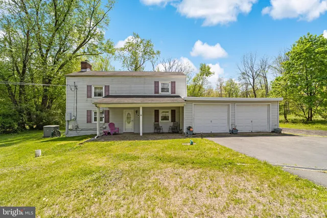 a view of a house with swimming pool and a yard