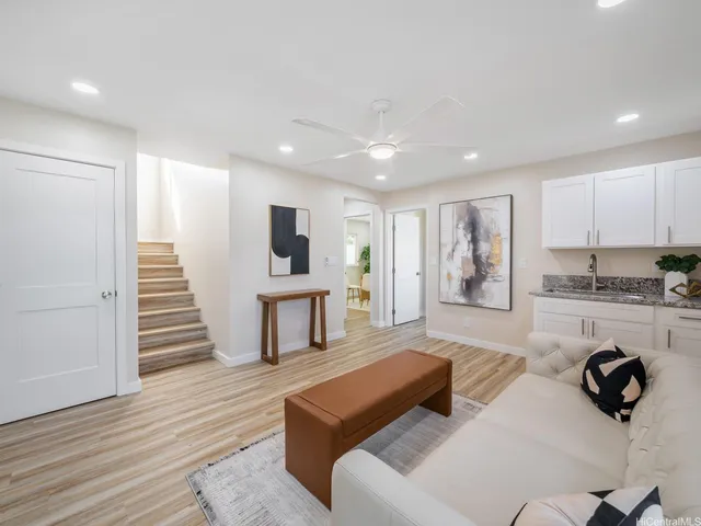 a living room with furniture and a wooden floor