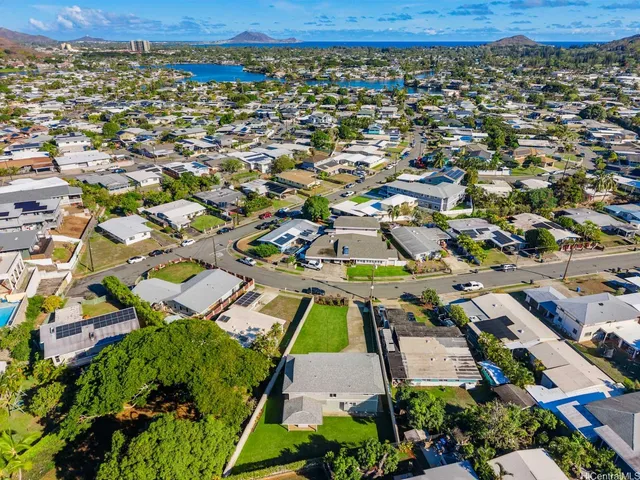 an aerial view of a residential apartment building with a yard