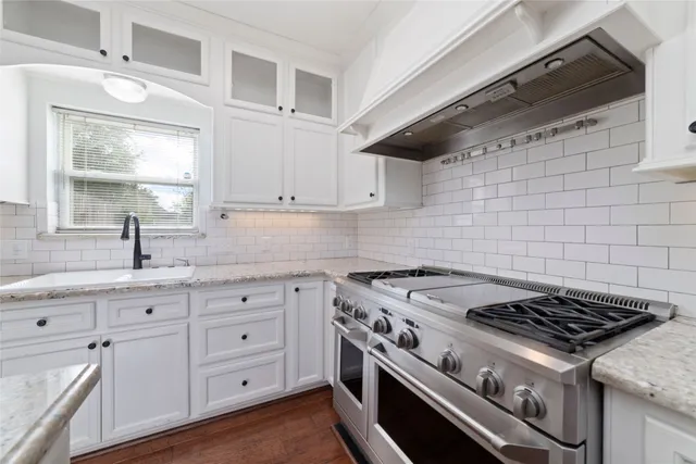 a white stove top oven sitting inside of a kitchen