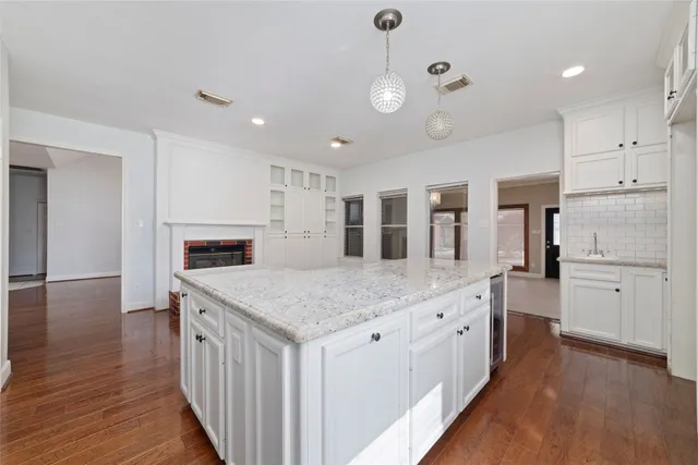 a kitchen with stainless steel appliances granite countertop stove top oven and refrigerator