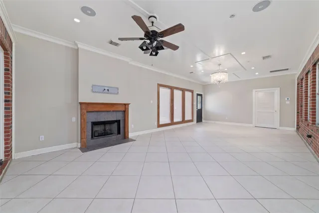 an empty room with fireplace and windows