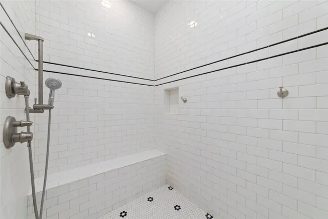 a bathroom with a shower and a shower