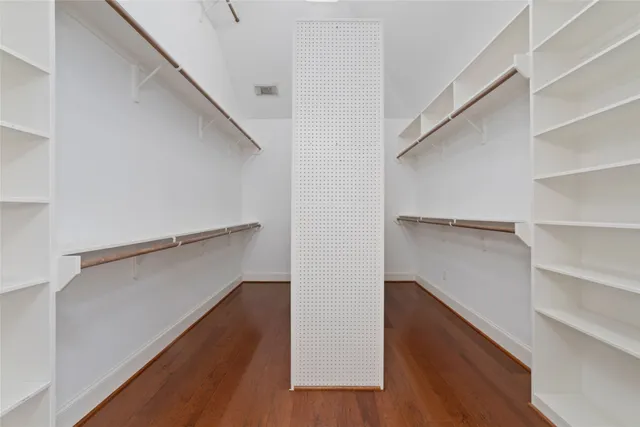 a view of walk in closet with empty racks
