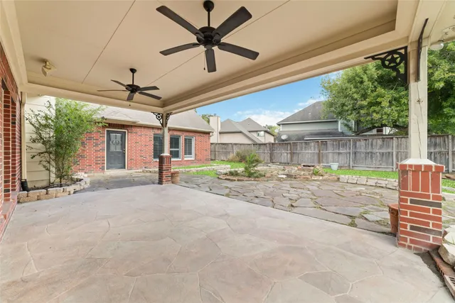 a view of a house with a patio and a yard