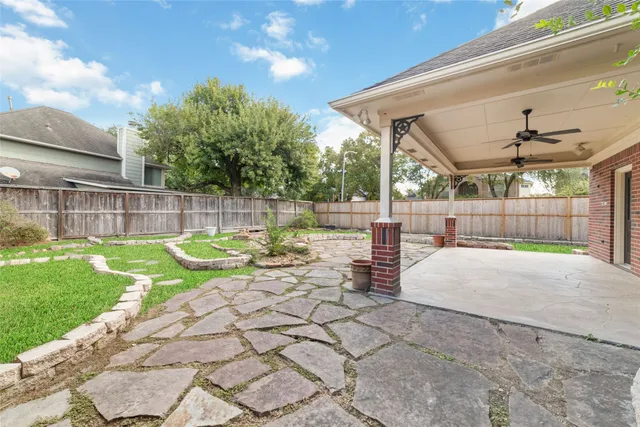 a view of yard with swimming pool and sitting area